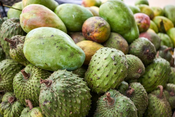 frutas em uma bancada, entre elas a graviola